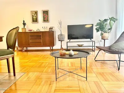 a living room with a table and a tv at Zen house in Athenian Riviera in Athens