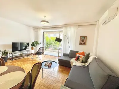 a living room with a couch and a table at Zen house in Athenian Riviera in Athens