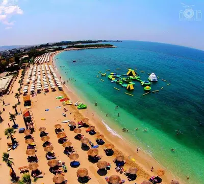an overhead view of a beach with umbrellas and the ocean at Zen house in Athenian Riviera in Athens