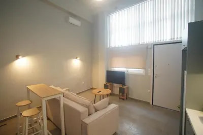 a living room with a couch and a table at Cozy Apartment Downtown Athens III in Athens