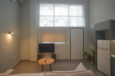 a living room with a couch and a table at Cozy Apartment Downtown Athens III in Athens