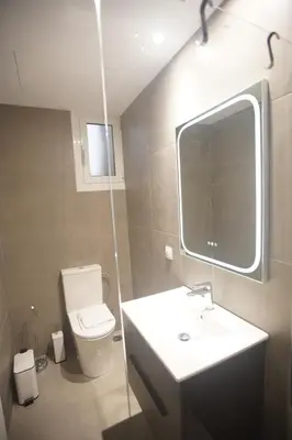 a bathroom with a sink and a toilet and a mirror at Cozy Apartment Downtown Athens III in Athens
