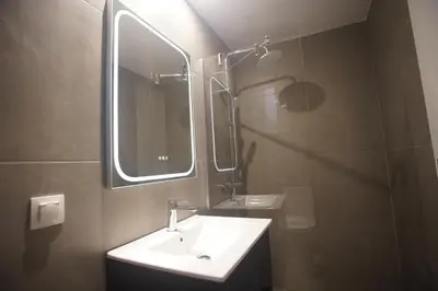 a bathroom with a sink and a mirror at Cozy Apartment Downtown Athens III in Athens