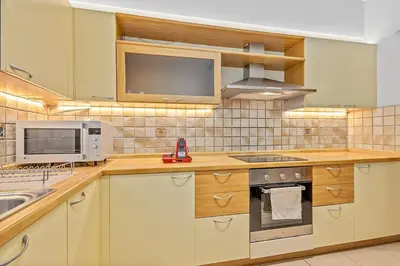 a kitchen with a stove and a microwave at Athens Acropolis Apartment in Athens