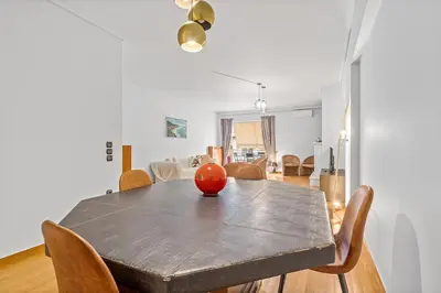 a dining room table with an orange on top of it at Athens Acropolis Apartment in Athens
