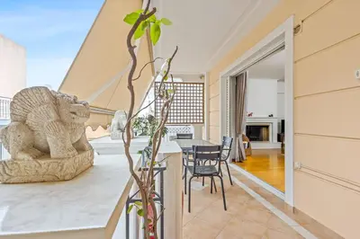 a dining room and living room with a table and chairs at Athens Acropolis Apartment in Athens