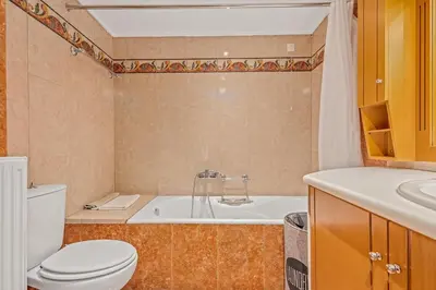 a bathroom with a tub and a toilet and a sink at Athens Acropolis Apartment in Athens