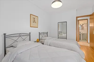 two beds in a white room with two mirrors at Athens Acropolis Apartment in Athens
