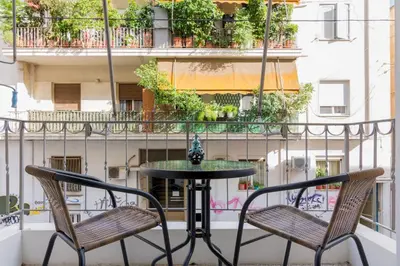 two chairs and a table on a balcony at Kipseli Dreams Stylish Apt, AC, WiFi in Athens