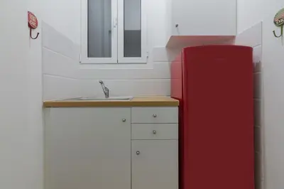 a kitchen with a red refrigerator and a sink at Kipseli Dreams Stylish Apt, AC, WiFi in Athens