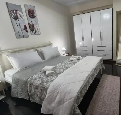 a bedroom with a large bed in a room at Piraeus City Center Apartment Port & Metro Dimotiko theatro in Piraeus