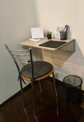 a chair sitting in front of a desk with a laptop at Piraeus City Center Apartment Port & Metro Dimotiko theatro in Piraeus