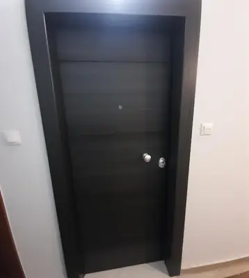 a black door with a silver knob in a room at Piraeus City Center Apartment Port & Metro Dimotiko theatro in Piraeus