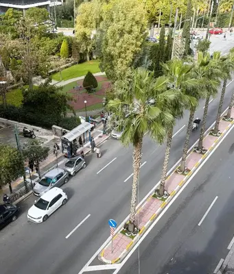 an aerial view of a street with cars and palm trees at Piraeus City Center Apartment Port & Metro Dimotiko theatro in Piraeus