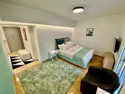 a bedroom with a bed and a chair in it at 4 Cups of Mint Tea in Athens