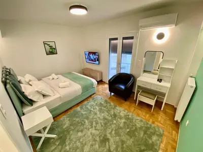 a bedroom with a bed and a desk and a mirror at 4 Cups of Mint Tea in Athens