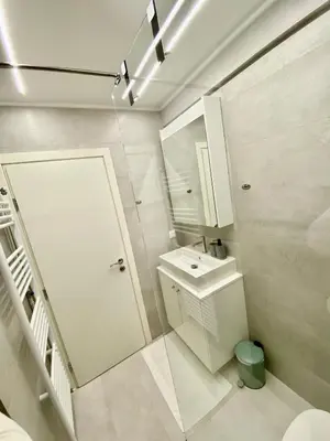 a white bathroom with a sink and a mirror at 4 Cups of Mint Tea in Athens