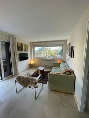 a living room with a couch and a window at Retro Chic 1 BR 1 Min to Sea in Athens