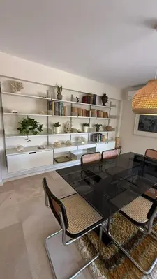 a dining room with a glass table and chairs at Retro Chic 1 BR 1 Min to Sea in Athens
