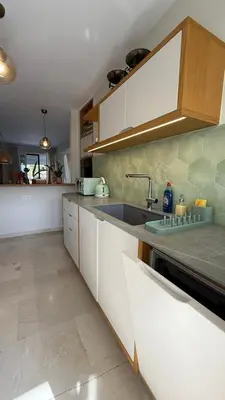 a kitchen with white cabinets and a sink at Retro Chic 1 BR 1 Min to Sea in Athens
