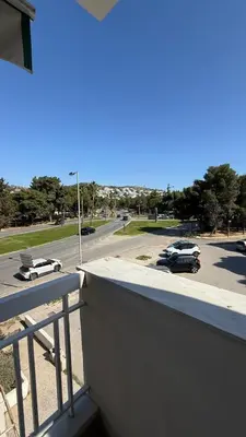 a balcony with a view of a parking lot at Retro Chic 1 BR 1 Min to Sea in Athens