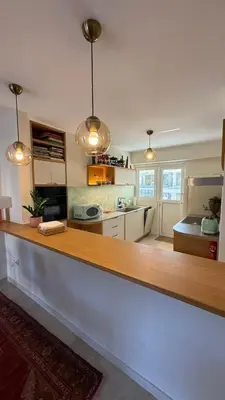 a kitchen with a wooden counter top in a room at Retro Chic 1 BR 1 Min to Sea in Athens