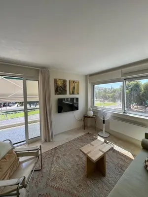 a living room with a couch and a table at Retro Chic 1 BR 1 Min to Sea in Athens