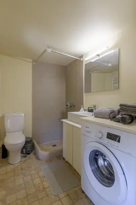 a bathroom with a washing machine and a toilet at Petrino pool house in Athens