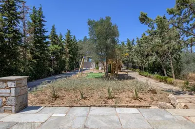 a park with a playground with a slide at Petrino pool house in Athens