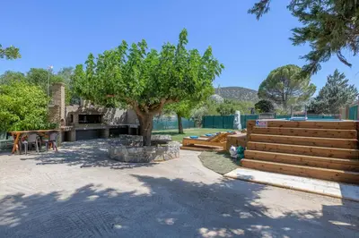 a park with a tree and a table and chairs at Petrino pool house in Athens
