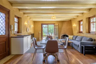 a living room with a couch and a table and chairs at Petrino pool house in Athens