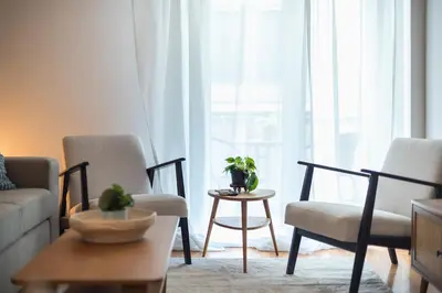 a living room with two chairs and a table at Zen Palm, Exarchia in Athens