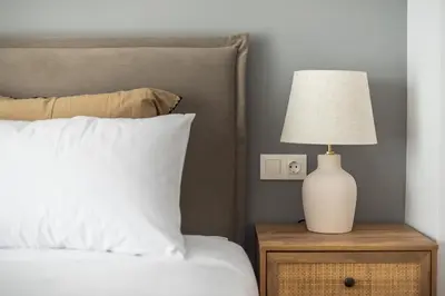a bedroom with a bed with a lamp on a night stand at Zen Palm, Exarchia in Athens