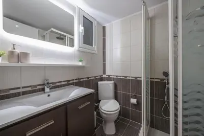 a bathroom with a toilet and a sink and a shower at Zen Palm, Exarchia in Athens