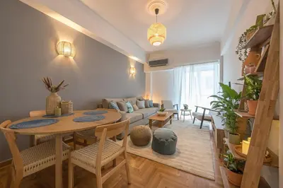 a living room with a table and a couch at Zen Palm, Exarchia in Athens