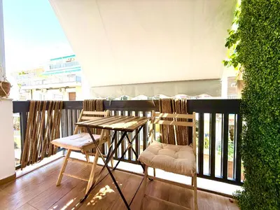a balcony with two chairs and a table on a balcony at Pagrati Cozy Lux Studio-Chremonidou street in Athens