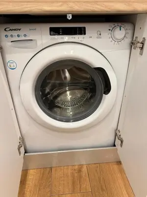 a washing machine with its door open in a room at Pagrati Cozy Lux Studio-Chremonidou street in Athens