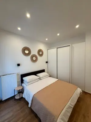 a bedroom with a bed and a mirror on the wall at Pagrati Cozy Lux Studio-Chremonidou street in Athens