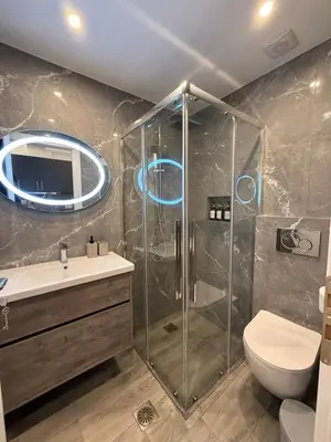 a bathroom with a shower and a toilet and a sink at Pagrati Luxury Gray Studio-Chremonidou street in Athens