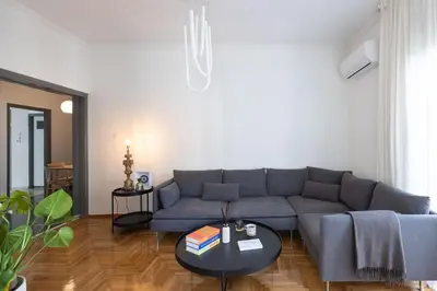 a living room with a couch and a table at Amazing flat just 500 m from Acropolis museum in Athens