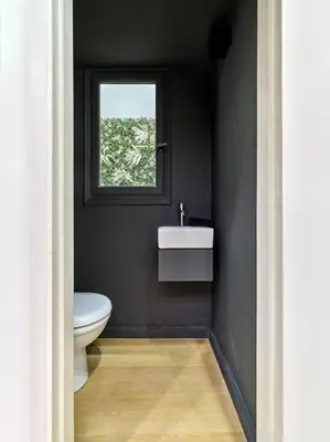 a bathroom with a white sink and a window at Adorac in Athens