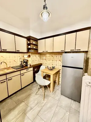 a kitchen with a refrigerator and a table at Near Acropolis-Athens in Athens