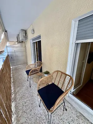 a patio with two chairs and a table on a balcony at Near Acropolis-Athens in Athens