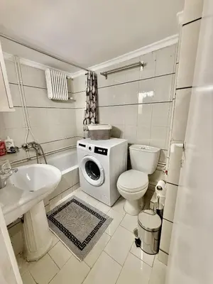 a bathroom with a washing machine and a toilet and a sink at Near Acropolis-Athens in Athens