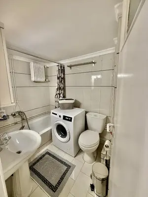 a bathroom with a toilet a sink and a washing machine at Near Acropolis-Athens in Athens