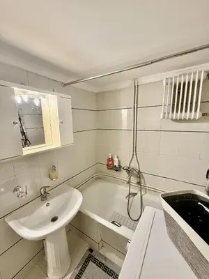 a white bathroom with a sink and a bath tub at Near Acropolis-Athens in Athens