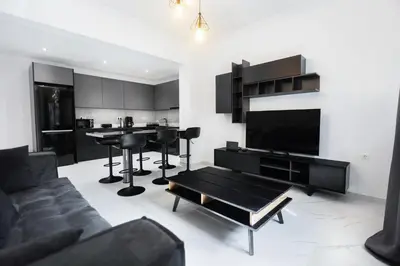 a living room with a couch and a table at Flouris Apartments in Athens
