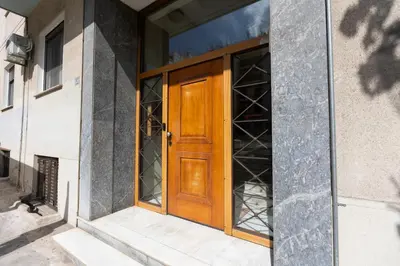 an open wooden door on a building at Flouris Apartments in Athens