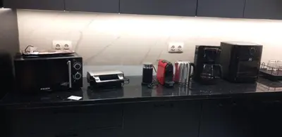 a kitchen counter with various appliances on it at Flouris Apartments in Athens