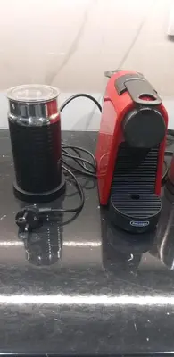 a red toaster and a cup on a table at Flouris Apartments in Athens